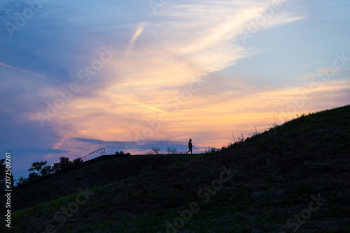 A person on Monks Mound at sunset.