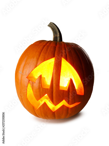 A carved Halloween pumpkin with glowing face