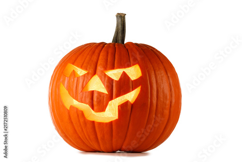 A carved Halloween pumpkin with glowing face