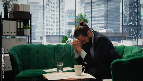 Fotografía Hopeless businessman works under pressure and despair while struggling with corporate downfall financial crisis and business failure