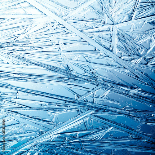 Ice frozen in intricate patterns of delicate crystals with brilliant contrast...