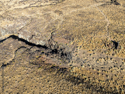 A UAV Drone view of the Fossil Falls Cinder Cone Red Hill Area on US 395 in the Owens Valley left over from vulcanism that built the Sierra Nevada mountain Range looking at the Fossil Falls Obsidian 