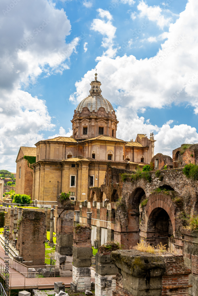 Fototapeta premium Ancient ruins of the Roman Forum and the church of Santi Luca e Martina in Rome Italy