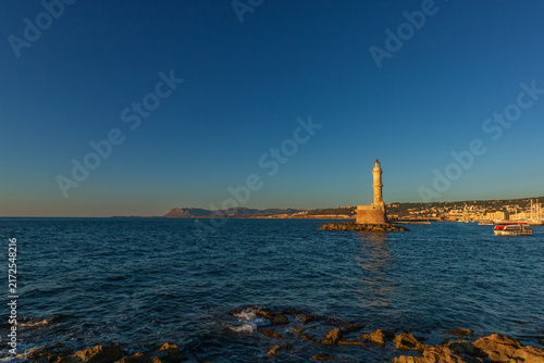 Picturesque old Venetian port of Chania Crete Greece with colorful waterfront buildings and historic lighthouse