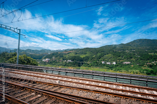 Bild auf Leinwand Railway tracks cross a green mountain valley in Wulong Chongqing China