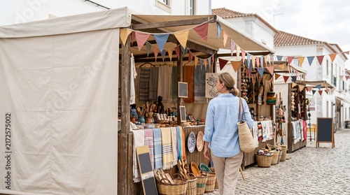 Tourist woman walking through an outdoor market street  