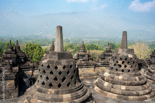 Photography Borobudur buddhist stupas on java island with mountains
