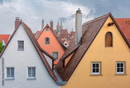 Traditional houses with steep tiled roofs overlooking the historic architecture of Rothenburg ob der Tauber, Germany.