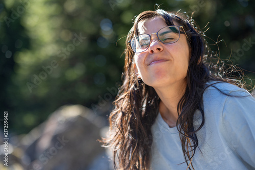 Quadro su tela Woman with wet hair and eyeglasses making a playful face in sunlight