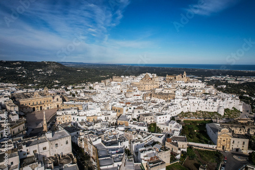 Canvastavla Aerial View of Ostuni's Whitewashed Old Town and Adriatic Sea Under Clear Blue S