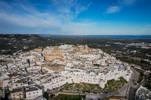Quadro su tela Aerial view of Ostuni, the White City, with its historic buildings under a cle