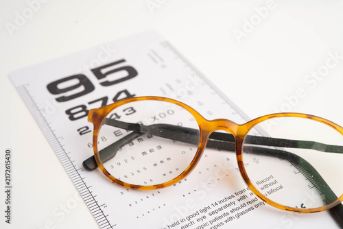 Konstfotografi Glasses on eye testing exam chart to check eyesight accuracy of reading