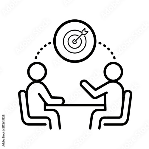 Strategic Business Meeting Two individuals collaborate on a common objective, symbolizing goal alignment, teamwork, and effective communication to achieve shared success