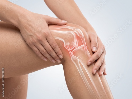 Knee Pain and Joint Anatomy Concept with Hands Supporting Leg