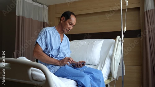 An elderly patient with respiratory problems sits dazed on the bed.(VDO 4K)	
