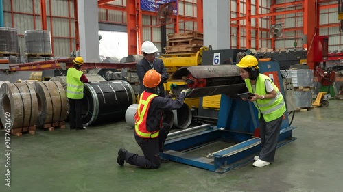 Engineers and staff are inspecting the assembly line system in a metal sheet and metal roofing manufacturing plant. (VDO 4K)	
