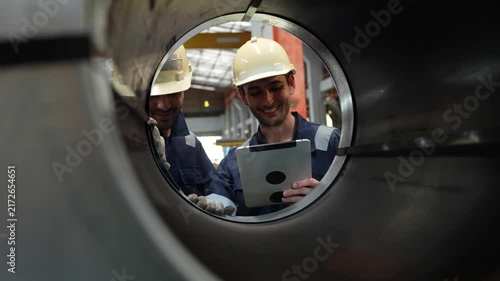 Engineers and staff are inspecting the assembly line system in a metal sheet and metal roofing manufacturing plant. (VDO 4K)	