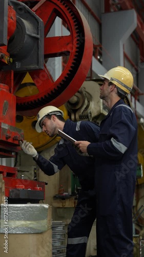 Engineers and staff are inspecting the assembly line system in a metal sheet and metal roofing manufacturing plant. (VDO 4K)	