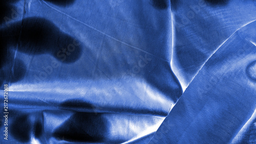 Quadro su tela Deep blue fabric with dark shadows and bright light reflections creating abstract patterns for backgrounds