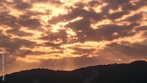 Wide angle time-lapse of scenic mountain range at sunset, dramatic cloud formations and natural beauty.