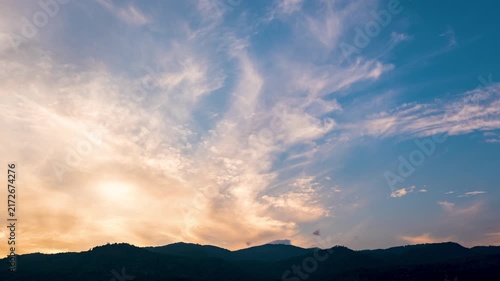 Time-lapse of evening sky changing from orange to deep blue at twilight.