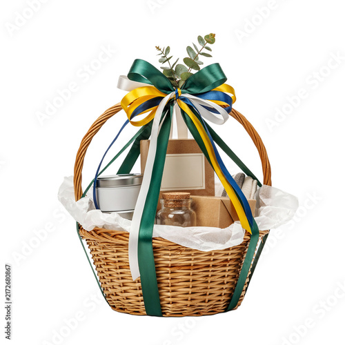A beautifully arranged gift basket filled with various items and adorned with a festive ribbon.
