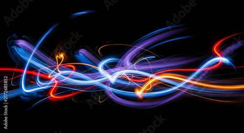 Dynamic Abstract Light Trails Creating Colorful Swirls and Waves in a Dark Space with a Sense of Motion and Energy