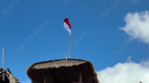 Indonesian Red and White Flag Flying Against a Clear Blue Sky


