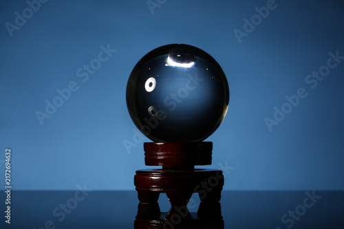 Fotografie Magical crystal ball on blue background