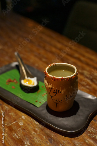 Konstfotografi A glass of a unique cocktail Kaprao Moo Krob Kai Dao Mai Sook (crispy pork with