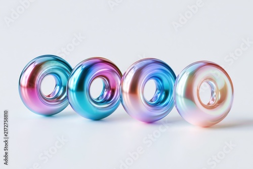 Four iridescent metallic torus shapes isolated on white background