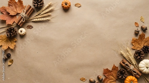 Thanksgiving day autumn flat lay background with maple leaves pine cones pumpkins wheat