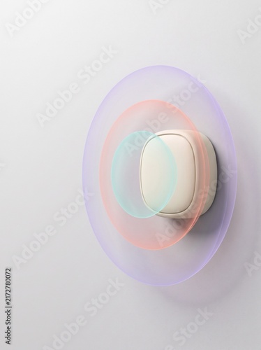 Close-up of pastel-colored vinyl record on white wall