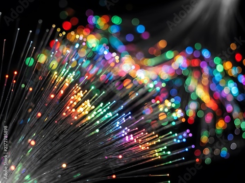 Colorful fiber optic lights close up rainbow bokeh glowing strands abstract technology background