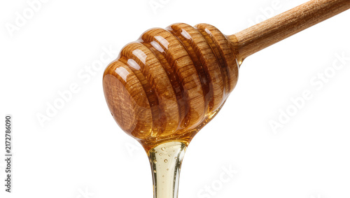 фотографія Wooden honey dipper with dripping golden honey, isolated on transparent backgrou