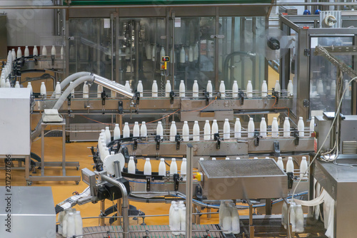 Cuadro en lienzo Automated dairy factory bottling line with milk bottles moving on conveyors