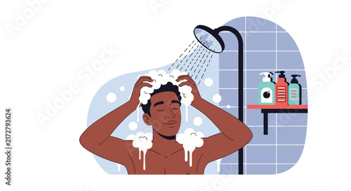 Young man with dark skin happily washing his hair with shampoo in the shower surrounded by white soap bubbles and foam.