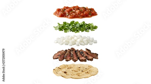 Exploded view of fresh steak taco ingredients layered on white background for food styling