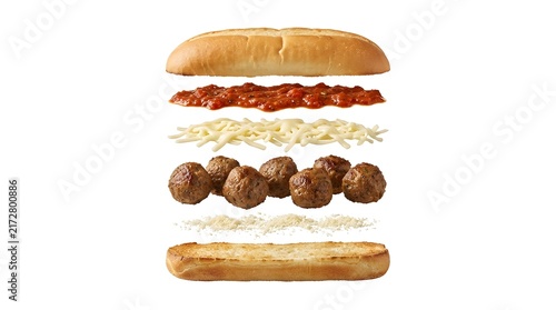 Close-up vertical meatball sub sandwich with marinara sauce and melted cheese on toasted bun
