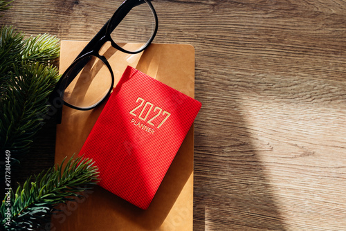 Planning new year goals for 2027 on wood desk