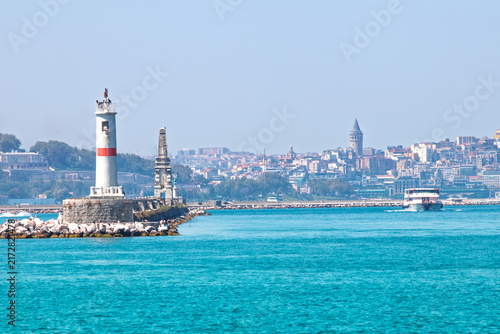 The lighthouse at the Kadıköy pier. View of the Galata Tower, the blue sea, the sky, and the lighthouse. Istanbul cityscape. Landscape. 