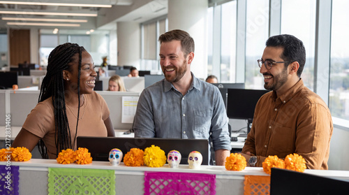 Three joyful coworkers celebrating in a modern office with Day of the Dead decor, perfect for internal corporate party and employee engagement content.