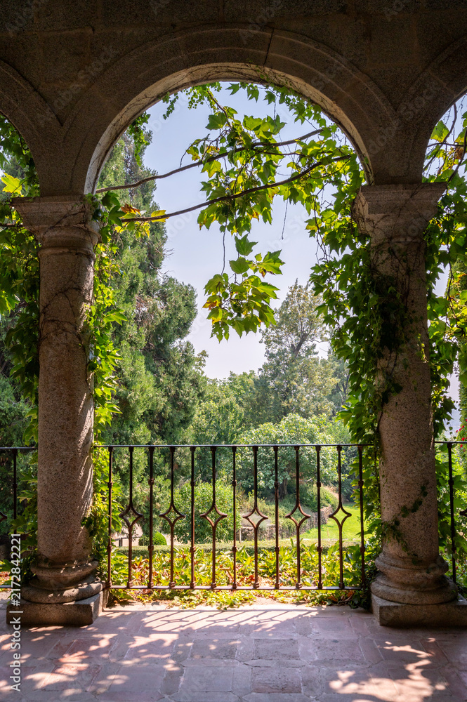 Naklejka premium Stone archway overlooking monastery garden