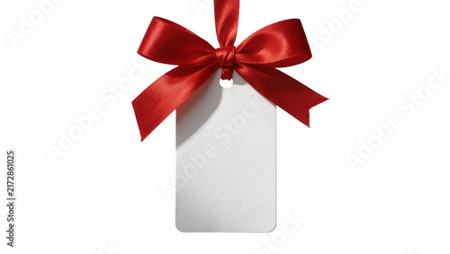 Fotografie Blank white gift tag with red satin ribbon bow, isolated on transparent backgrou