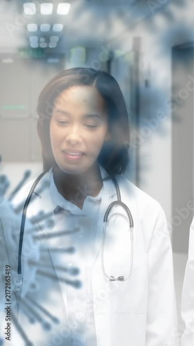 Animation of 3d covid 19 cells floating over doctors in hospital