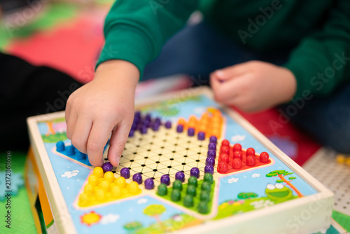 Konstfotografi High-angle view of children and an adult playing a star-shaped peg game