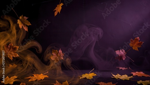 dramatic moody halloween background with swirling fog and autumn leaves perfect for seasonal promotional text overlay