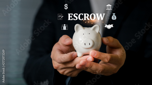 A person holding a piggy bank with glowing financial Escrow, a deposit or asset deposited with a third party, investment, and economic growth, symbolizing savings and financial planning.