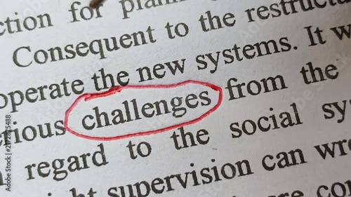 Closeup of hand with red ink pen mark circle around to emphasize or highlight challenges word on article, book or magazine paper. Person facing mental and physical health challenges symbolic concept.