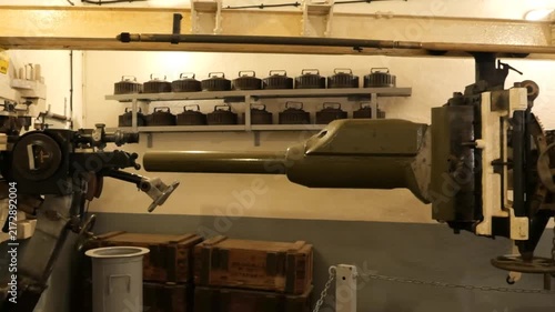 Inside a WWII French Maginot Line bunker with gun and ammo storage.